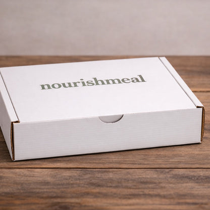White box with 'nourishmeal' branding on a wooden surface