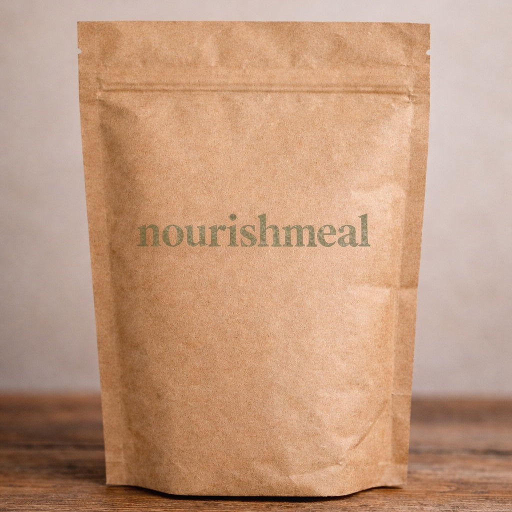 Kraft paper pouch with 'nourishmeal' branding on a wooden surface.